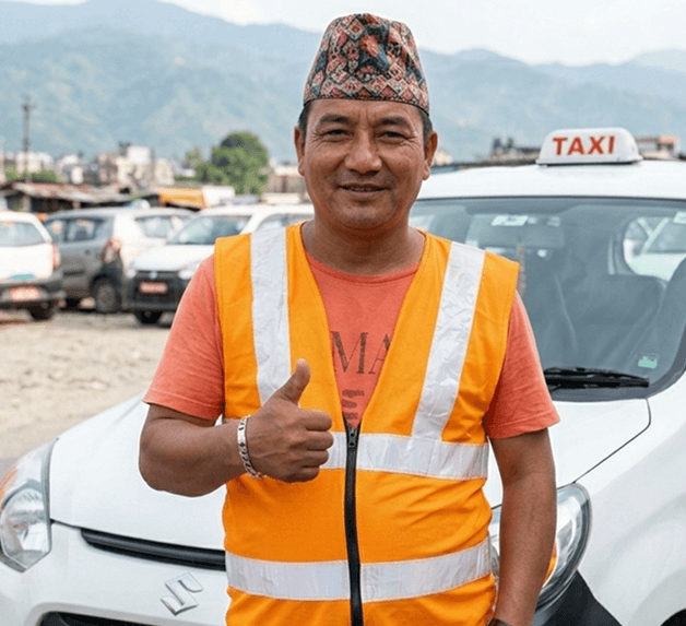 Partner driver standing in front of taxi